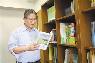 藤岛昭在东京理科大学办公室里翻阅其撰写的《科学家与中国古典名言集》一书。记者 刘军国摄