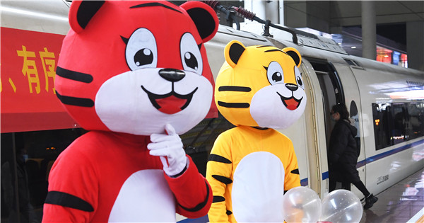 Train attendants dress up to greet upcoming Year of the Tiger