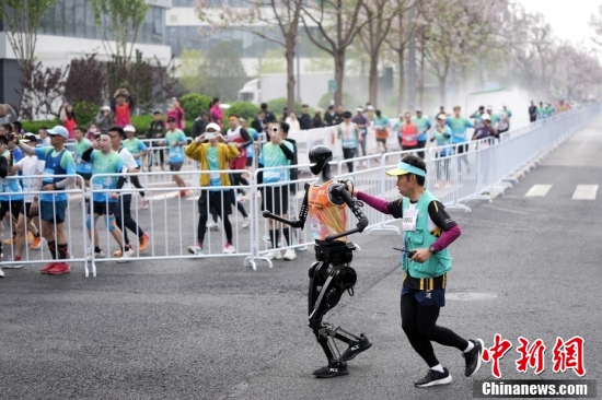 Robotic participant "Tiangong Ultra" competes as engineers run alongside during the Beijing E-Town half-marathon and humanoid robots half-marathon in the Beijing Economic-Technological Development Area, April 19, 2025. (Photo/China News Service) Robotic participant "Tiangong Ultra" competes as engineers run alongside during the Beijing E-Town half-marathon and humanoid robots half-marathon in the Beijing Economic-Technological Development Area, April 19, 2025. (Photo/China News Service)