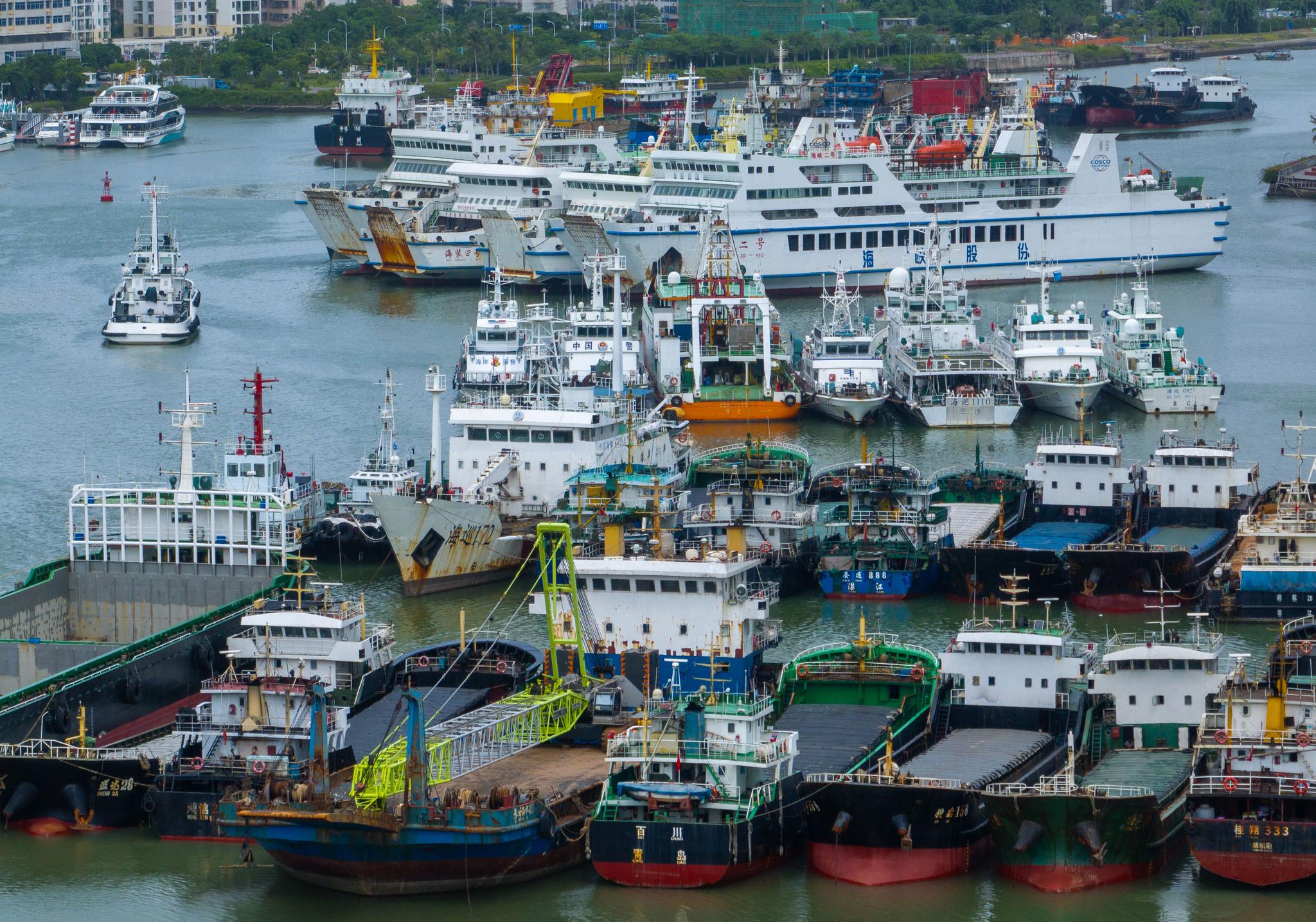 Boats moor at port in S China's Hainan for shelter as Typhoon Kajiki intensifies