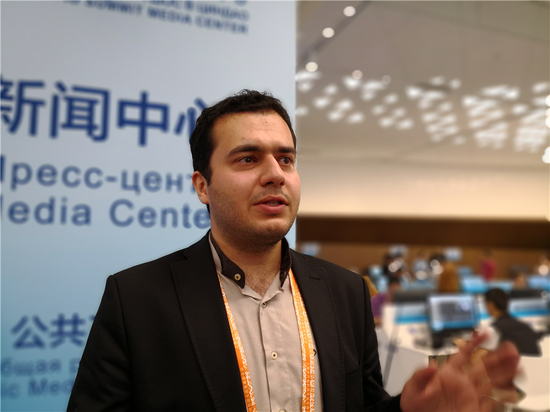 Mostafa Rouhani Nejad, a reporter from Iran's official media, is interviewed at the media center in Qingdao for the 18th Shanghai Cooperation Summit, June 10, 2018. (Photo by Sun Ruonan/chinadaily.com.cn)