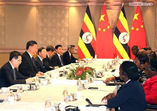 Chinese President Xi Jinping meets with his Ugandan counterpart Yoweri Museveni in Johannesburg, South Africa, July 26, 2018. (Xinhua/Liao Yujie)