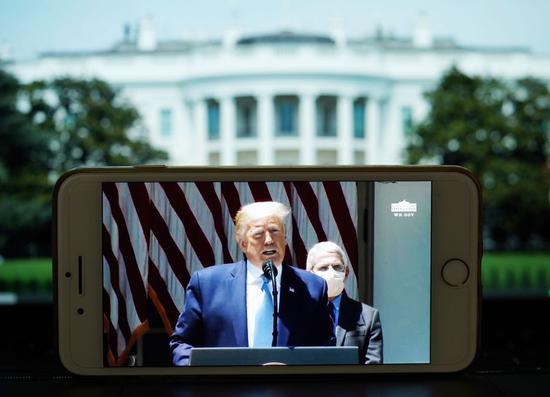 Photo taken on May 15, 2020 shows the live broadcast of U.S. President Donald Trump speaking at a press briefing at the White House in Washington D.C., the United States. (Xinhua/Liu Jie)