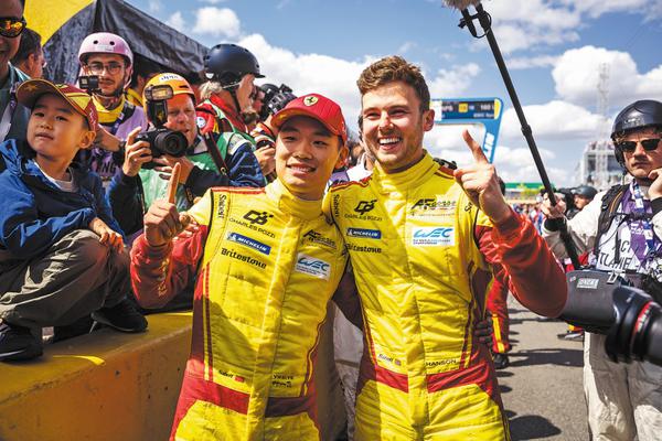 China's Ye Yifei (left) and British teammate Phil Hanson pose for pictures following their win at Le Mans on June 15. Looking ahead, Ye's schedule for the second half of the season will take him to the United States, Japan and back to France, as he sets his sights on the next goal: winning the FIA World Endurance Championship title. PHOTOS PROVIDED TO CHINA DAILY