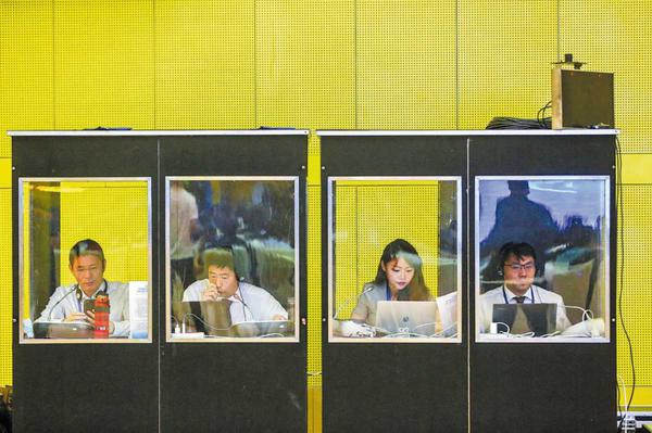 Interpreters work at the 5th Global Cross-Border E-Commerce Conference in Zhengzhou, Henan province, in May 2021. CHINA DAILY