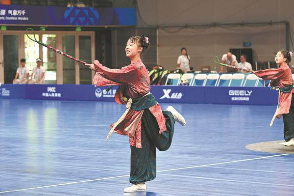  Children stage a performance with brocade sticks used to play the ancient sport of buda ball last week during the 2025 World Games in Chengdu, Sichuan province. CHINA DAILY