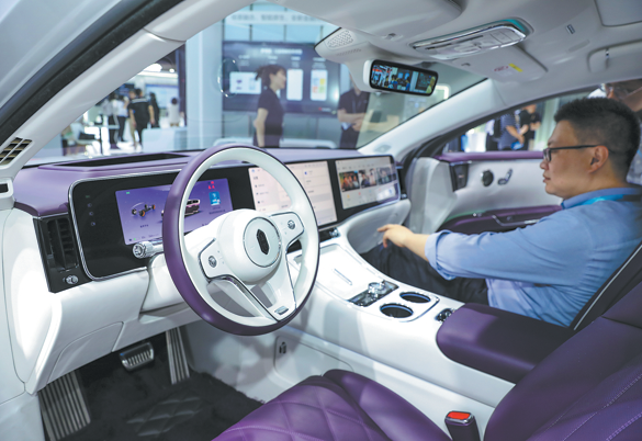 A visitor tries out a Maextro S800, a battery electric ultra-luxury sedan co-developed by Huawei and JAC Group, during an expo in Shanghai on June 19. Photo/CHINA DAILY