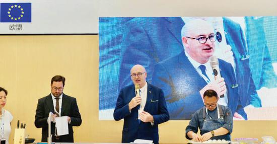 Phil Hogan, European Union commissioner for agriculture and rural development, speaks at a tasting event in the pavilion of the European Union, the Region of Honour, at the SIAL China exhibition in Shanghai. (Photo provided to China Daily)