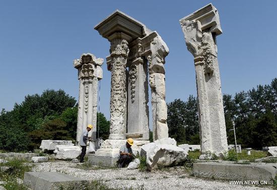 Staff members clean up weeds at ruins of Yuanying Guan (Immense Ocean Observatory) at Yuanmingyuan in Beijing, capital of China, May 23, 2018. The four-month reinforcement project of ruins of Immense Ocean Observatory at the historical site of Yuanmingyuan started lately.(Xinhua/Luo Xiaoguang)