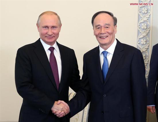 Chinese Vice President Wang Qishan meets with Russian President Vladimir Putin, in Russia's St. Petersburg, May 24, 2018. (Xinhua/Yao Dawei)