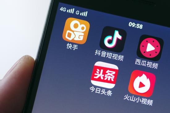 Mobile video apps including Kuaishou, Douyin, Xigua and Huoshan are displayed on the screen of a 4G smartphone. (Photo provided to China Daily)