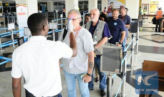 Passengers queue to be screened for symptoms of Ebola at Uganda's Entebbe International Airport on May 15, 2018. (Xinhua/Joseph Kiggundu)