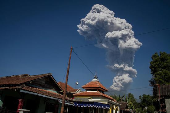 Indonesia's Merapi volcano ejects towering column of ash