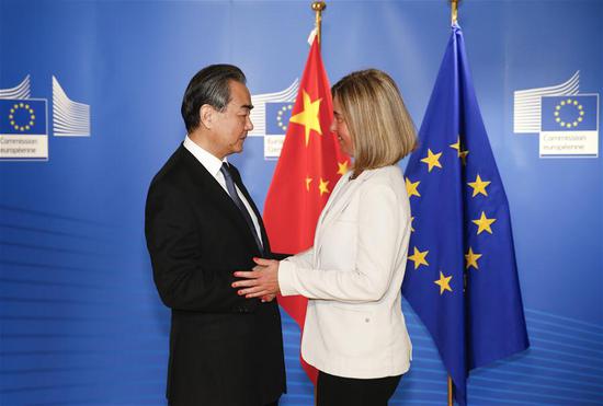 Chinese State Councilor and Foreign Minister Wang Yi (L) shakes hands with EU foreign policy chief Federica Mogherini at the eighth China-EU High Level Strategic Dialogue in Brussels, Belgium, on June 1, 2018. (Xinhua/Ye Pingfan)