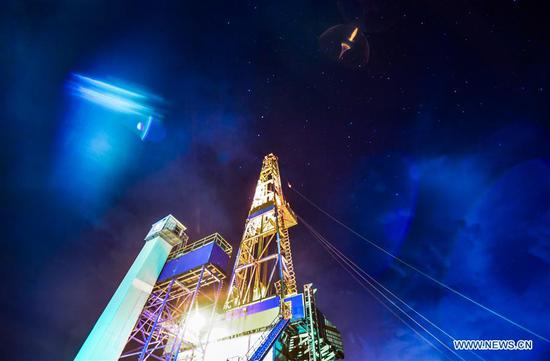 The Crust 1 land-based drilling rig system is seen at night in the Songliao Basin in northeast China, June 1, 2018. Crust 1, a land-based drilling rig, concluded its first mission on Saturday, putting China among the frontrunners in onshore drilling, along with Germany and Russia. Jointly developed by Jilin University and Sichuan-based Honghua Group, Crust 1 can dig as deep as 10,000 meters and is China's most advanced land-based drilling rig. (Xinhua/Xu Chang)