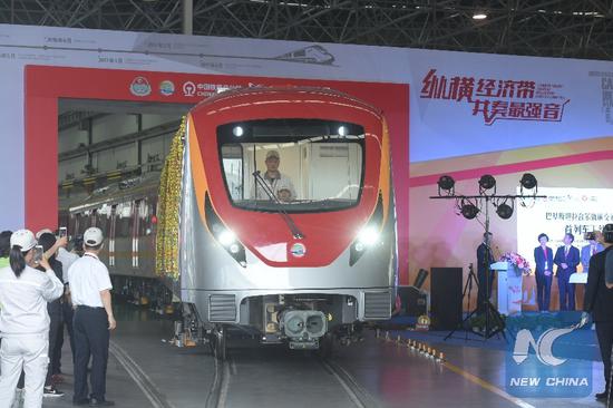 Photo taken on May 15, 2017 shows a new subway train made for Pakistan Lahore Orange Line Project at the CRRC Zhuzhou Locomotive Co., Ltd. in Zhuzhou, central China's Hunan Province. A train designed for a Pakistani subway rolled off the production line in central China's Hunan Province on Monday, the first of 27. The train with five coaches was designed for the 25.58 km Orange Line Metro in Lahore, Pakistan's second largest city. (Xinhua/Long Hongtao)