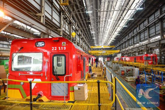 Photo taken on July 27, 2017 shows two Chinese locomotives to be assembled at the Transnet Engineering Koedoespoort Plant in Pretoria, South Africa. 305 of the 554 locally assembled locomotives have been delivered to South Africa since October 2012 when the South Africa state rail company Transnet contracted the Chinese Zhuzhou Electric Locomotives Company under the Chinese locomotive manufacturer CRRC to supply first 95 locomotives. (Xinhua/Zhai Jianlan)