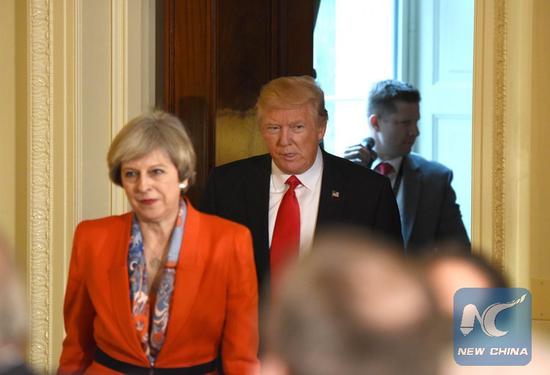 File Photo: U.S. President Donald Trump and British Prime Minister Theresa May (front) arrive for a joint press conference at the White House in Washington D.C., the United States, Jan. 27, 2017. (Xinhua/Yin Bogu)