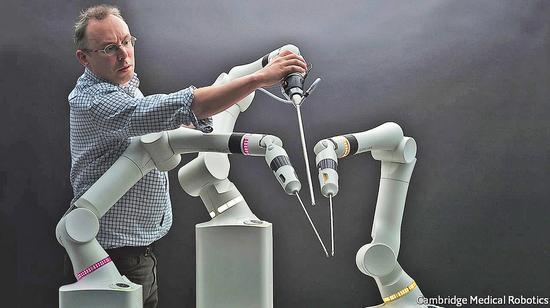 CMR technical director Luke Hares seen here alongside surgical robot Versius. (Photo provided to China Daily)