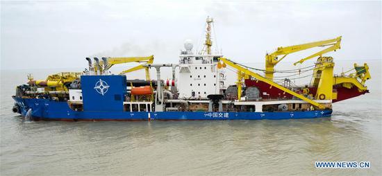 Chinese-built dredging vessel Tian Kun Hao, the largest of its kind in Asia, departs a port for its first sea trial, in Qidong, east China's Jiangsu Province, June 8, 2018. (Xinhua/Li Xiang)