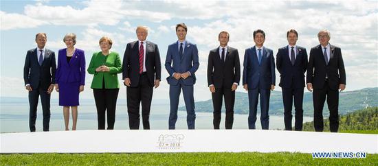 Participants of the Group of Seven (G7) summit European Union Council President Donald Tusk, British Prime Minister Theresa May, German Chancellor Angela Merkel, U.S. President Donald Trump, Canadian Prime Minister Justin Trudeau, French President Emmanuel Macron, Japanese Prime Minister Shinzo Abe, Italian Prime Minister Giuseppe Conte and European Commission President Jean-Claude Juncker (from L to R) pose for a group photo on the first day of the G7summit in La Malbaie, Quebec, Canada, June 8, 2018. (Xinhua/POOL)