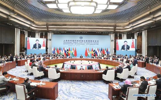 The 18th Meeting of the Council of Heads of Member States of the Shanghai Cooperation Organization (SCO) is held in Qingdao, east China's Shandong Province, June 10, 2018. Chinese President Xi Jinping chaired the meeting and delivered a speech. (Xinhua/Ding Lin)