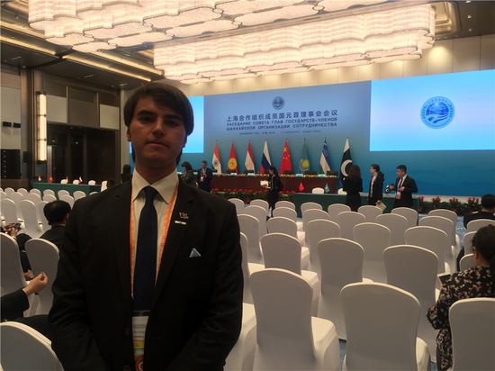 Akifi Ahmad Khaibar, a reporter from Sputnik News/Afghanistan, poses for a photo in Qingdao for the 18th Shanghai Cooperation Summit, June 10, 2018. (Photo by Guo Rong/chinadaily.com.cn)