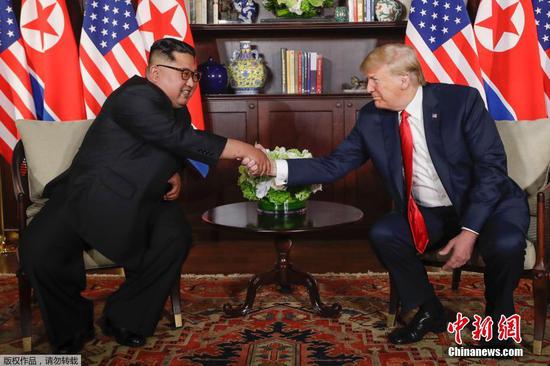 Top leader of the Democratic People's Republic of Korea (DPRK) Kim Jong Un (L) and U.S. President Donald Trump share a historic handshake Tuesday morning in Singapore. (Photo/Agencies)