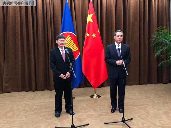 Chinese State Councillor and Foreign Minister Wang Yi (R) addresses reporters in Beijing about the summit between the Democratic People’s Republic of Korea (DPRK) leader Kim Jong Un and U.S. President Donald Trump, June 12, 2018. (Photo/CGTN)