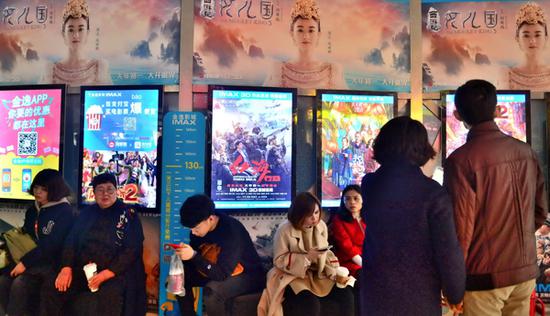 Moviegoers read film synopses on a wall display at a cinema in Nankai district, Tianjin. (Photo provided to China Daily)