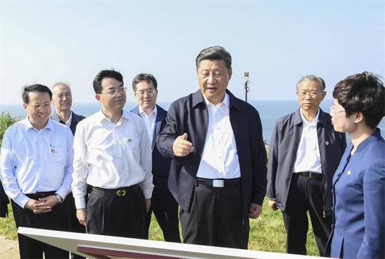 President Xi Jinping, also general secretary of the Communist Party of China Central Committee, visits the site of an imperial fort on Tuesday at Liugong Island in Weihai, Shandong province. Xi called for boosting maritime sectors during his tour in the Province. (Photo/Xinhua)