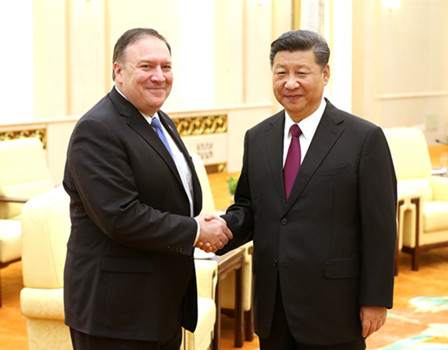 President Xi Jinping greets US Secretary of State Mike Pompeo at the Great Hall of People in Beijing late on Thursday. Xi stressed Beijing's support for further cooperation between Washington and Pyongyang. (FENG YONGBIN / CHINA DAILY)