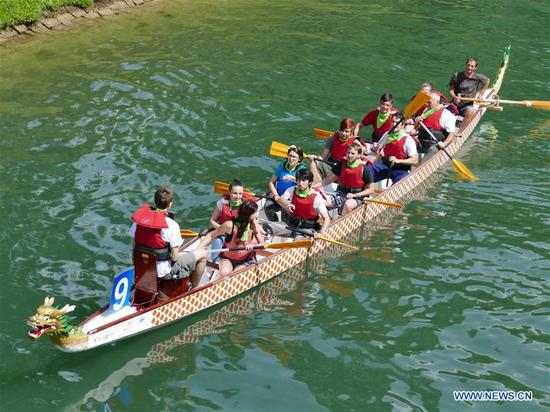 People participate in the dragon boat race in Ljubljana, Slovenia, on June 16, 2018. A dragon boat race was held on the Ljubljanica River in Ljubljana on Saturday. The event was organized by the Confucius Institute of the University of Ljubljana to celebrate Chinese traditional Duanwu Festival, or Dragon Boat Festival. (Xinhua/Wang Yaxiong)
