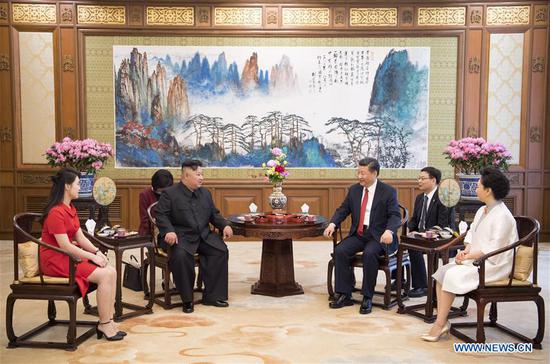 Xi Jinping (3rd R), general secretary of the Central Committee of the Communist Party of China (CPC) and Chinese president, meets with Kim Jong Un (3rd L), chairman of the Workers' Party of Korea (WPK) and chairman of the State Affairs Commission of the Democratic People's Republic of Korea (DPRK), at the Diaoyutai State Guesthouse in Beijing, capital of China, June 20, 2018. Xi's wife Peng Liyuan (1st R) and Kim's wife Ri Sol Ju (1st L) also attended the meeting. (Xinhua/Li Xueren)