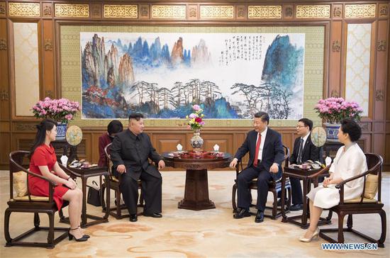 Xi Jinping (3rd R), general secretary of the Central Committee of the Communist Party of China (CPC) and Chinese president, meets with Kim Jong Un (3rd L), chairman of the Workers' Party of Korea (WPK) and chairman of the State Affairs Commission of the Democratic People's Republic of Korea (DPRK), at the Diaoyutai State Guesthouse in Beijing, capital of China, June 20, 2018. Xi's wife Peng Liyuan (1st R) and Kim's wife Ri Sol Ju (1st L) also attended the meeting. (Xinhua/Li Xueren)