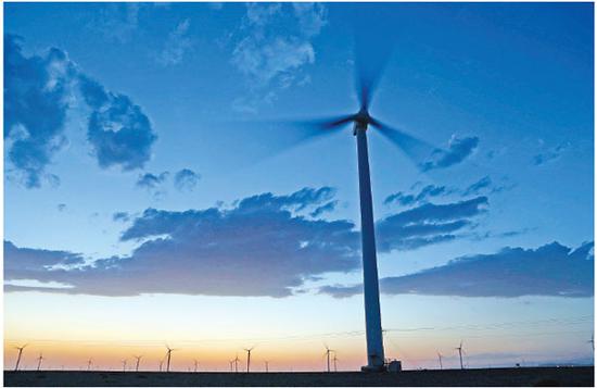 A wind turbine system generates energy in the Xinjiang Uygur autonomous region. (Photo/Xinhua)