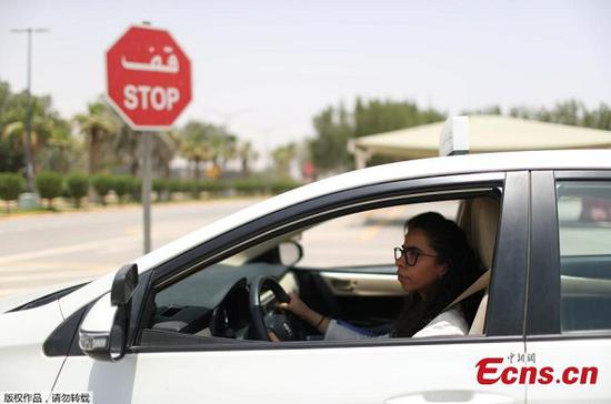 Trainee Maria al-Faraj stops the car at a stop sign during a driving lesson with her instructor at Saudi Aramco Driving Center in Dhahran, Saudi Arabia, June 6, 2018. (Photo/Agencies)