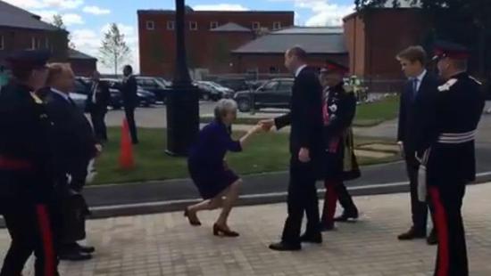 British Prime Minister Theresa May curtseys to Prince William at Defense and National Rehabilitation Center in Nottinghamshire, UK, June 21, 2018. /Screenshot from Twitter