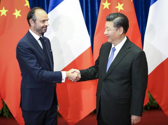 President Xi Jinping meets French Prime Minister Edouard Philippe at the Great Hall of the People in Beijing on Monday. Xi said China appreciates France’s proactive participation in building the Belt and Road. (FENG YONGBIN / CHINA DAILY)