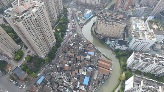 Aerial photo taken on Jan 9, 2017 shows view of Zhangqiao, one of the largest shantytowns, and surrounding estate in Hongkou district, Shanghai.  (Photo/Xinhua)
