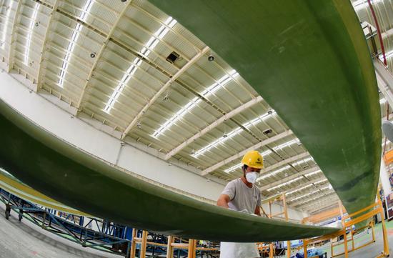 An employee works on the production line of a wind-power equipment manufacturer in Lianyungang, Jiangsu Province. (Photo/CHINA DAILY)