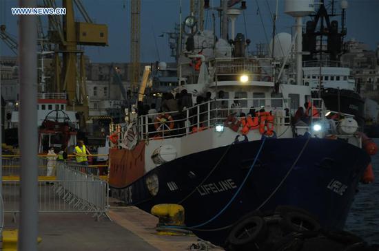 Migrants wait to disembark from the migrant rescue vessel MV Lifeline at Boiler Wharf in Senglea, Malta, on June 27, 2018. The migrant rescue vessel MV Lifeline arrived in Malta on Wednesday, resolving a week-long international standoff over the vessel's fate. (Xinhua/Yuan Yun)