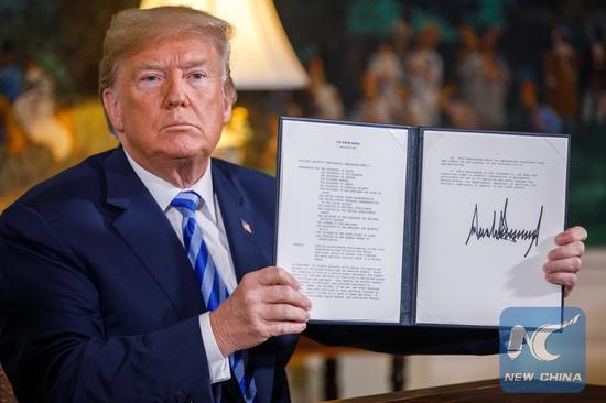 U.S. President Donald Trump displays a signed presidential memorandum at the White House in Washington D.C., the United States, on May 8, 2018. Trump said that the United States will withdraw from the Iran nuclear deal, a landmark agreement signed in 2015. (Xinhua/Ting Shen)