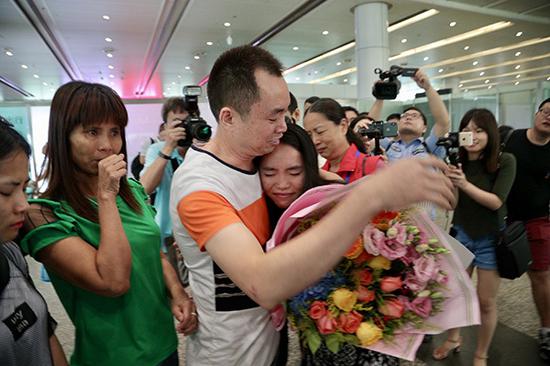 Zhong Fengmin and her father hug each other at the Guangzhou Baiyun International Airport, Guangdong Province, July 1, 2018. (Photo: Public Security Bureau of Shunde District)