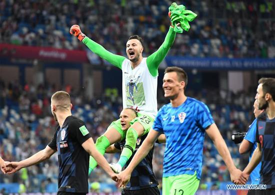 Goalkeeper Danijel Subasic (top) of Croatia greets the audience with teammates after the 2018 FIFA World Cup round of 16 match between Croatia and Denmark in Nizhny Novgorod, Russia, July 1, 2018. Croatia won 4-3 (3-2 in penalty shootout) and advanced to the quarter-final. (Xinhua/Lui Siu Wai)