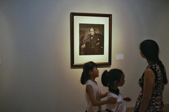 A portrait of the late British prime minister Winston Churchill is among the exhibits. (Photo by Jiang Dong/China Daily)