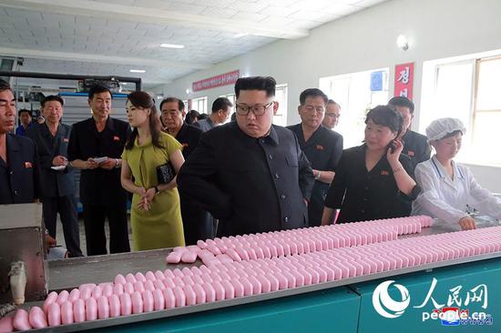 DPRK leader Kim Jong Un and his wife visit a company in Sinuiju, a border city next to China's Dandong City, July 2, 2018. /People.cn Photo