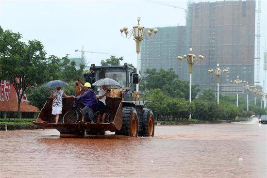 A forklift runs on a flooded road in Fuzhou City, east China's Jiangxi Province, July 6, 2018. Heavy rain continued to batter southern provinces of China. (Xinhua/He Jianghua)