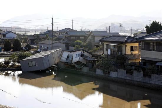 Photo taken on July 10, 2018, shows submerged and destroyed houses in a flooded area in Kurashiki, Okayama Prefecture, Japan. (Xinhua/Ma Ping)
