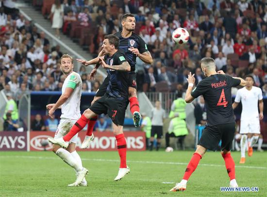 Dejan Lovren (top) of Croatia competes for a header during the 2018 FIFA World Cup semi-final match between England and Croatia in Moscow, Russia, July 11, 2018. (Xinhua/Yang Lei)